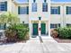 Charming townhome exterior with green shutters, well-maintained landscaping, and inviting front doors at 245 Cape Harbour Loop # 103, Bradenton, FL 34212