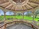 View from inside a wooden gazebo in a park with green grass and blue skies at 245 Cape Harbour Loop # 103, Bradenton, FL 34212