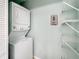 This laundry room features a stacked washer and dryer unit and wire shelving at 245 Cape Harbour Loop # 103, Bradenton, FL 34212