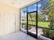 This patio features a ceiling fan, a screened-in enclosure, and a door to the outside at 245 Cape Harbour Loop # 103, Bradenton, FL 34212