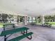 A sheltered picnic area offers tables with green tops and views of the surrounding green space at 245 Cape Harbour Loop # 103, Bradenton, FL 34212