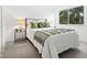 Sun-filled bedroom with a metal bed frame, bright lamp, and plush green accents at 2748 Orchid Oaks Dr # 202, Sarasota, FL 34239