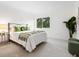 Bright bedroom boasts soft carpet, large windows, and calming green decor at 2748 Orchid Oaks Dr # 202, Sarasota, FL 34239
