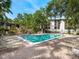 Refreshing community pool offers a relaxing escape, surrounded by greenery and lounge chairs at 2748 Orchid Oaks Dr # 202, Sarasota, FL 34239