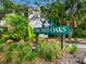 Welcoming Orchid Oaks sign surrounded by lush tropical landscaping at 2748 Orchid Oaks Dr # 202, Sarasota, FL 34239