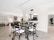 Sunlit dining area with sleek furniture and an open layout to the kitchen and living space at 2748 Orchid Oaks Dr # 202, Sarasota, FL 34239