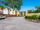 Apartment building featuring well-maintained landscaping and convenient parking at 2748 Orchid Oaks Dr # 202, Sarasota, FL 34239