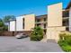 Well-lit exterior shot of the apartment complex showing lush landscaping and convenient parking at 2748 Orchid Oaks Dr # 202, Sarasota, FL 34239