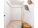 Bright hallway with tile flooring, closet space, and decorative wall art at 2748 Orchid Oaks Dr # 202, Sarasota, FL 34239