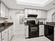 Efficient kitchen with black appliances and plenty of cabinet space at 2748 Orchid Oaks Dr # 202, Sarasota, FL 34239