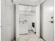 Functional laundry room is equipped with modern washer, dryer, and shelving at 2748 Orchid Oaks Dr # 202, Sarasota, FL 34239