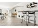 Open-concept living area with stylish decor, tile flooring, and an adjacent dining space at 2748 Orchid Oaks Dr # 202, Sarasota, FL 34239