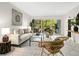 Sun-filled living room with elegant decor and glass doors that lead to a cozy balcony at 2748 Orchid Oaks Dr # 202, Sarasota, FL 34239