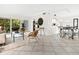 Well-lit living space showcasing an open design leading to a dining area and a cozy balcony at 2748 Orchid Oaks Dr # 202, Sarasota, FL 34239