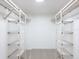 Spacious walk-in closet features custom shelving providing ample storage at 2748 Orchid Oaks Dr # 202, Sarasota, FL 34239