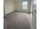 An empty bedroom with neutral walls, carpet, and a window for natural light at 2824 Rock Sound St, Bradenton, FL 34208