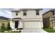 Charming two-story home features a two-car garage, well-maintained lawn, and covered front porch at 2824 Rock Sound St, Bradenton, FL 34208