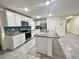 Modern kitchen features white cabinets, stainless appliances, and a granite island at 2824 Rock Sound St, Bradenton, FL 34208