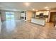 Open-concept living room with fireplace and view of the modern kitchen at 2824 Rock Sound St, Bradenton, FL 34208