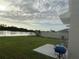 Backyard overlooking a serene lake, offering a peaceful retreat with a patio and green space at 2824 Rock Sound St, Bradenton, FL 34208
