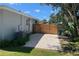 Backyard with new fence, gravel area, and air conditioning unit along the exterior wall of the home at 3011 Bougainvillea St, Sarasota, FL 34239