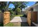 Backyard features a fenced yard, well-maintained lawn, and a gravel area at 3011 Bougainvillea St, Sarasota, FL 34239
