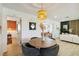 Cozy dining area featuring stylish decor, a modern light fixture, and a view into the living room at 3011 Bougainvillea St, Sarasota, FL 34239