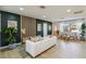 Stylish living room with a chic sofa, wood accent wall, and abundant natural light at 3011 Bougainvillea St, Sarasota, FL 34239