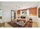 Serene main bedroom with an accent wall, stylish lighting, and a modern sliding closet door at 3011 Bougainvillea St, Sarasota, FL 34239