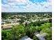 An aerial view shows a neighborhood with mature trees, landscaped lawns, and community amenities at 3236 Kingswood Dr, Sarasota, FL 34232