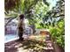 The backyard features an inground pool, mature trees, and a fenced perimeter at 3236 Kingswood Dr, Sarasota, FL 34232