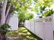 The backyard features a privacy fence and shed surrounded by mature trees and greenery at 3236 Kingswood Dr, Sarasota, FL 34232
