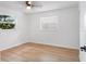 Bright bedroom featuring two windows and wood-look flooring at 3236 Kingswood Dr, Sarasota, FL 34232