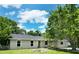 Charming single-story home with a well-manicured lawn, lush landscaping, and bright white window trim at 3236 Kingswood Dr, Sarasota, FL 34232