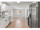 A bright kitchen with stainless steel appliances, white cabinets, modern hardware, and wood-look floors at 3236 Kingswood Dr, Sarasota, FL 34232