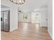 Open floor plan featuring wood-look floors, stainless steel appliances, and stylish lighting at 3236 Kingswood Dr, Sarasota, FL 34232