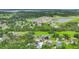 Aerial view of a residential property with a mix of green spaces, houses, and a small lake nearby at 3511 39Th E St, Palmetto, FL 34221