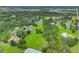 An aerial view of a large, grass-covered property surrounded by trees and residential homes at 3511 39Th E St, Palmetto, FL 34221