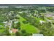 Aerial view of a property featuring an expansive lawn, interspersed with mature trees and houses at 3511 39Th E St, Palmetto, FL 34221