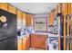 Functional kitchen with wood cabinets, essential appliances, and a sink, offering a practical space for meal preparation at 3511 39Th E St, Palmetto, FL 34221