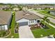 Aerial view of a nicely landscaped home with a driveway, palm trees, and colorful flower beds at 3602 Quiet Dr, Sarasota, FL 34240