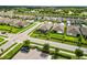 An aerial view of a residential neighborhood showcasing well-maintained homes and landscaping near a scenic body of water at 3602 Quiet Dr, Sarasota, FL 34240