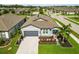 Aerial view of a well-maintained home with a driveway, tropical landscaping and attached garage at 3602 Quiet Dr, Sarasota, FL 34240