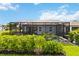 Relaxing backyard pool with a screened enclosure, lush landscaping, and gray exterior elevation at 3602 Quiet Dr, Sarasota, FL 34240