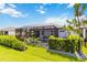 Backyard pool area with modern screened enclosure, landscaping, and gray house exterior at 3602 Quiet Dr, Sarasota, FL 34240