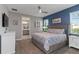 A primary bedroom boasts an ensuite bath, a king size bed, and modern decor at 3602 Quiet Dr, Sarasota, FL 34240