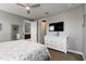 View of the bedroom and dresser featuring a television, doors leading to an ensuite and closet at 3602 Quiet Dr, Sarasota, FL 34240
