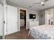 View of the bedroom featuring a large closet, a television, and doors leading to the ensuite at 3602 Quiet Dr, Sarasota, FL 34240