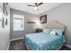 A brightly lit bedroom featuring a queen size bed and gray walls at 3602 Quiet Dr, Sarasota, FL 34240