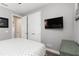 A bedroom with white trim, gray walls, a television, closet and ensuite entrance at 3602 Quiet Dr, Sarasota, FL 34240